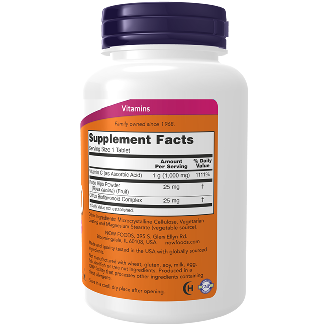 A Vitamin C-1000 supplement bottle from Now Foods, featuring a white design with a purple cap. Its label prominently displays "Supplement Facts," showcasing ingredients such as Vitamin C for enhancing collagen synthesis, rose hips powder, and a citrus bioflavonoid complex to provide immune support.