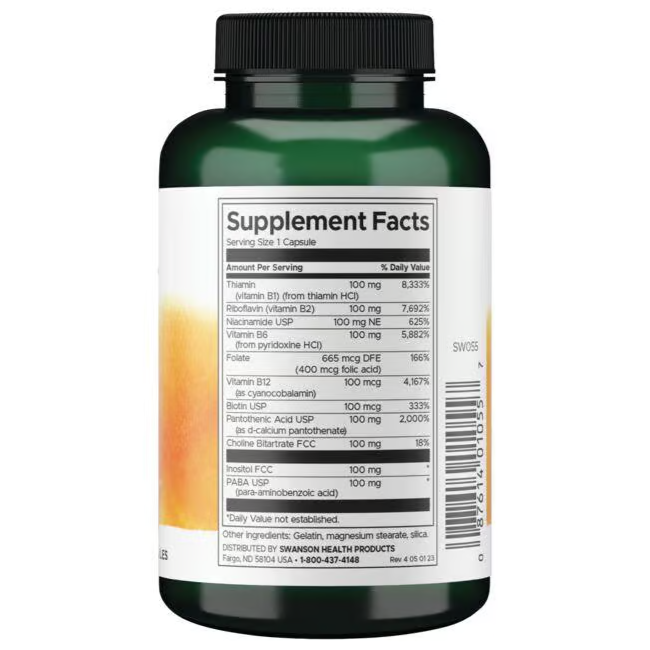 A green bottle of Swanson Balance Vitamin B-100 Complex 100 Capsules prominently displays the Supplement Facts label, detailing vitamins and daily values for metabolic support.