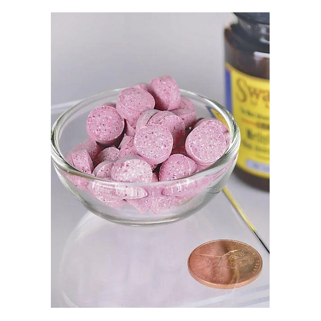 A bowl of Swanson's round, pink Vitamin B-12 - 5000 mcg methylcobalamin tablets sits beside a penny for size comparison, showcasing their compact form. A brown bottle in the background alludes to the neurologically active benefits these B12 supplements provide.