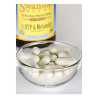 Thumbnail for A glass bowl of white capsules stands before a bottle labeled 