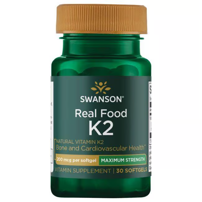 A green bottle of Swanson's Real Food Vitamin K2 offers 200 mcg of Menaquinone-7 per softgel, supporting bone and cardiovascular health, with 30 softgels derived from Natto.