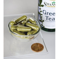 Vignette d'une bouteille de thé vert Swanson - 500 mg 100 gélules avec un penny à côté.
