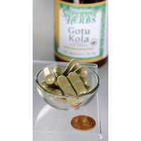 Miniature pour Un flacon d'extrait de Gotu Kola Swanson - 100 mg 120 gélules se trouve à côté d'un bol.