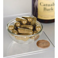Vignette de Swanson Écorce de Catuaba - 465 mg 120 gélules dans un bol à côté d'une bouteille.