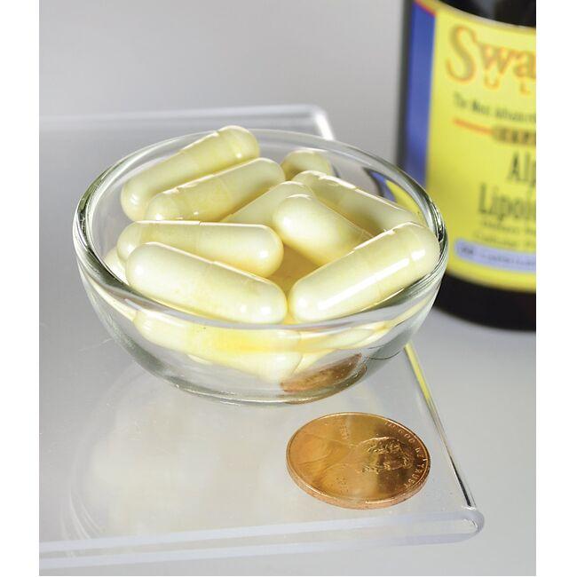 Un bol d'acide alpha-lipoïque Swanson - 300 mg 60 gélules avec une pièce de monnaie à côté.
