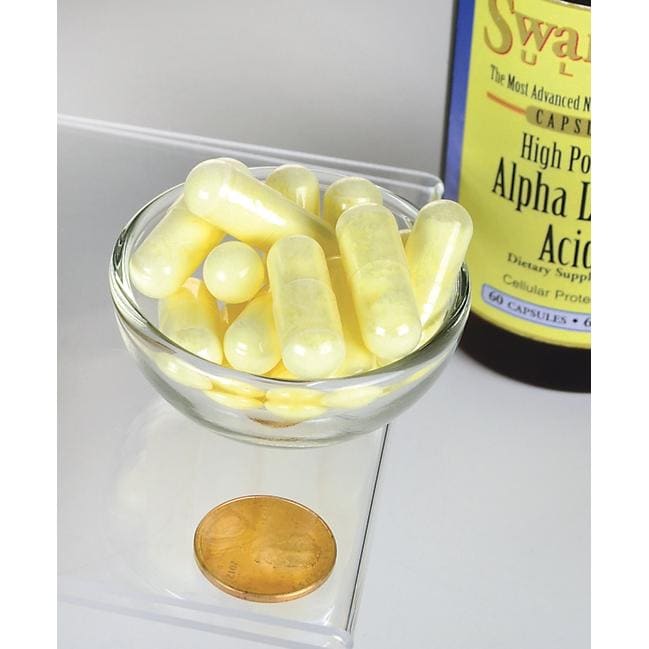 Une bouteille de Swanson Alpha Lipoic Acid - 600 mg 60 gélules avec une pièce de monnaie à côté.