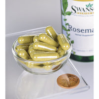 Vignette d'un bol contenant un flacon de Swanson Rosemary - 400 mg 90 capsules, une herbe riche en antioxydants, et un penny.